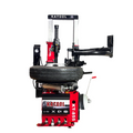 Vertical tire press machine with red base and black press arm, side view.