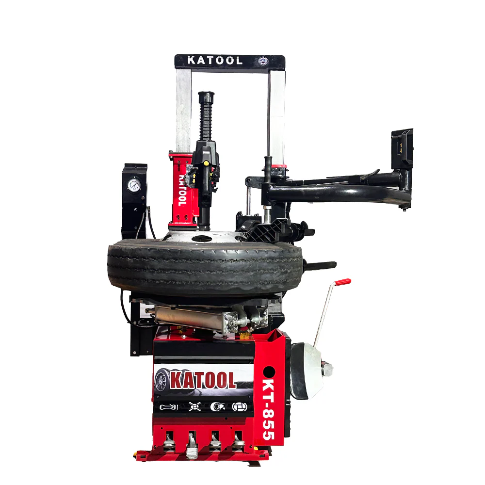 Vertical tire press machine with red base and black press arm, side view.