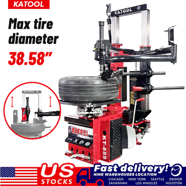 Vertical tire press with mounted large tire and black overhead clamp, studio view.
