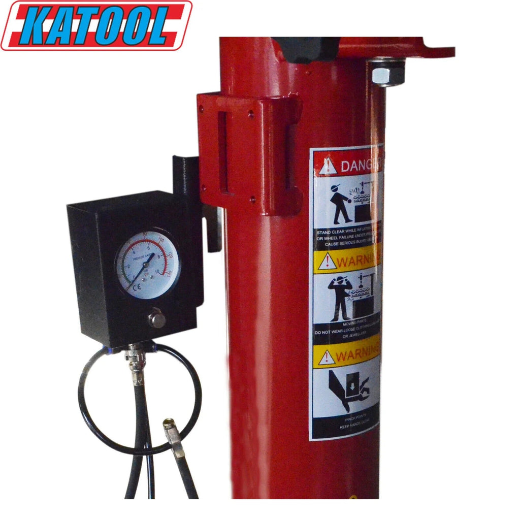 Wheel balancer column with pressure gauge, safety warning label, and connected cable