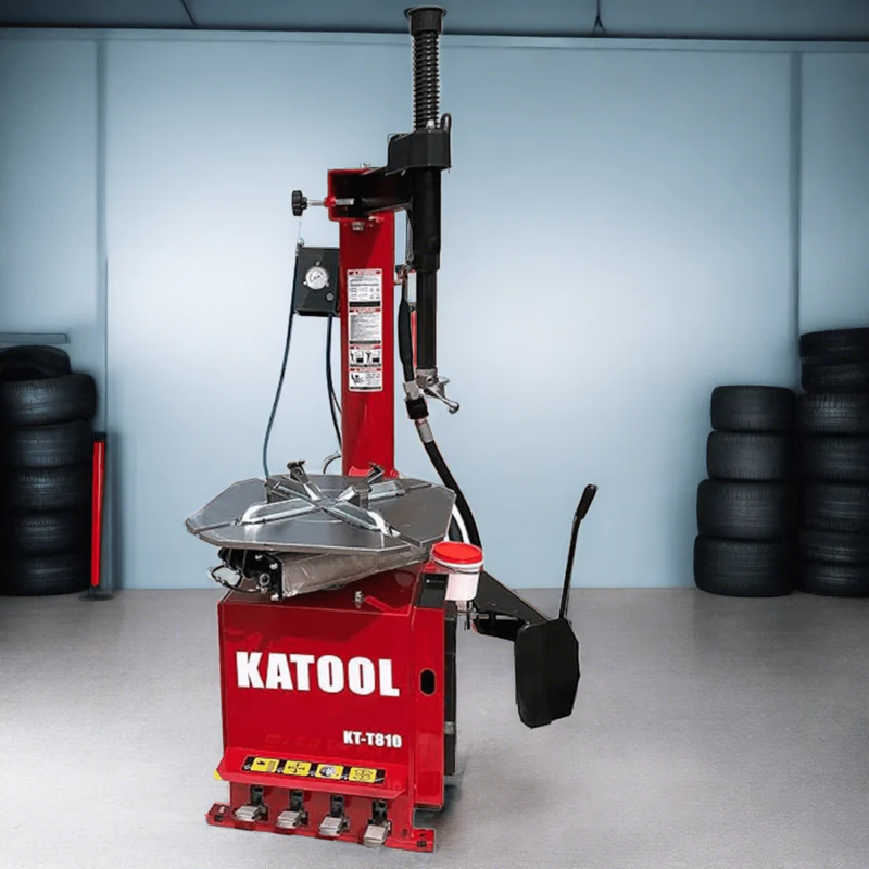 Red tire changer machine with vertical column, mounting head, and side tool arm
