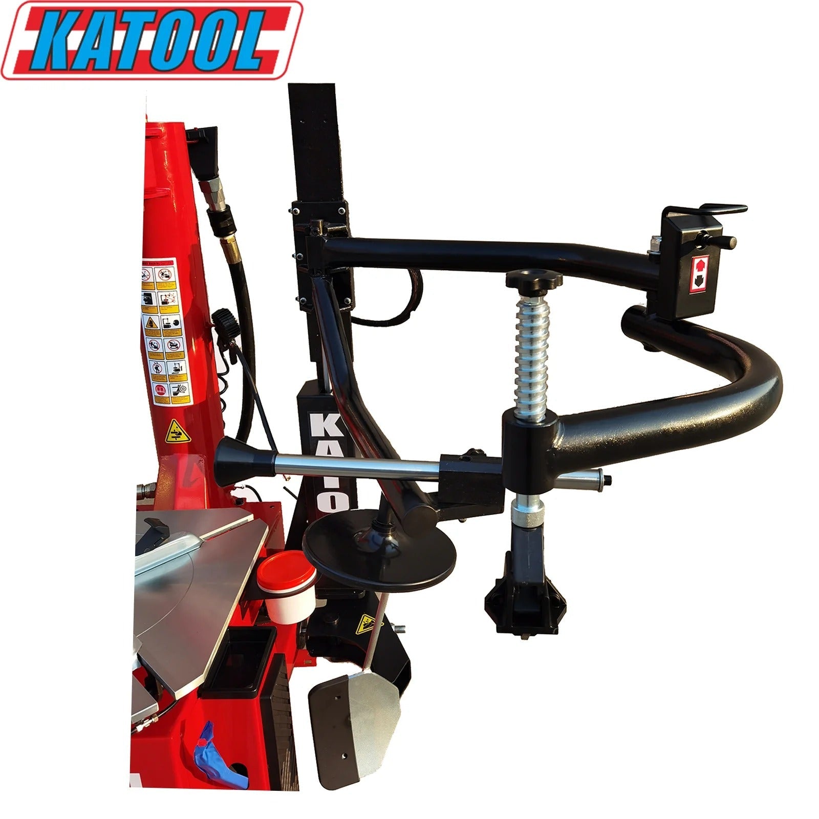 Tire changer with red frame and black assist arm, spring-loaded vertical posts