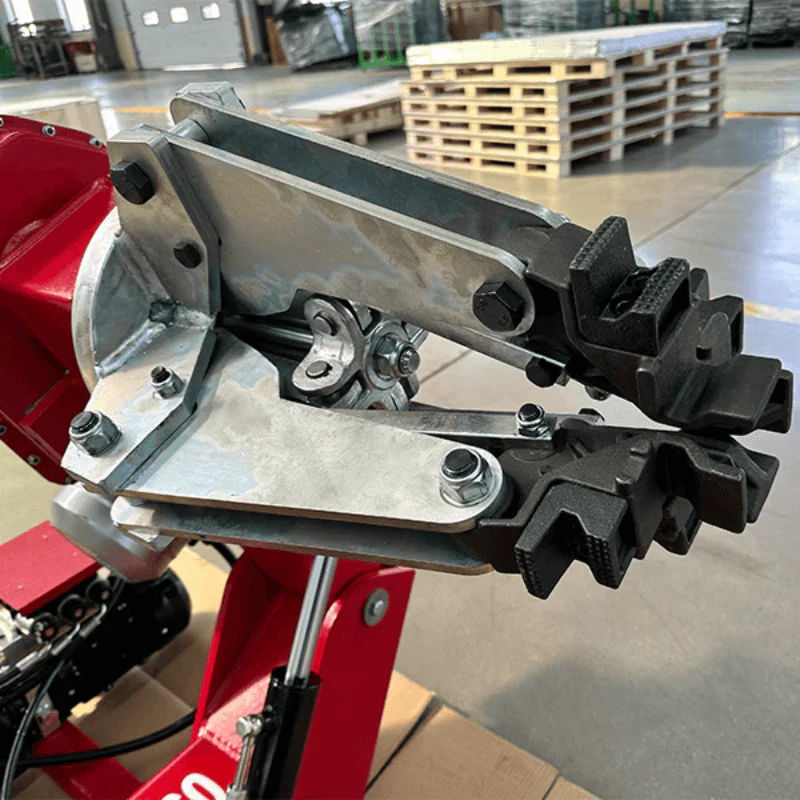 Metal tire mounting tool and bead breaker on red tire changer base