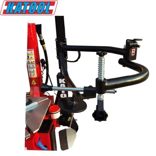 Tire changer with red frame, curved bead-breaking arm, and metal mounting head