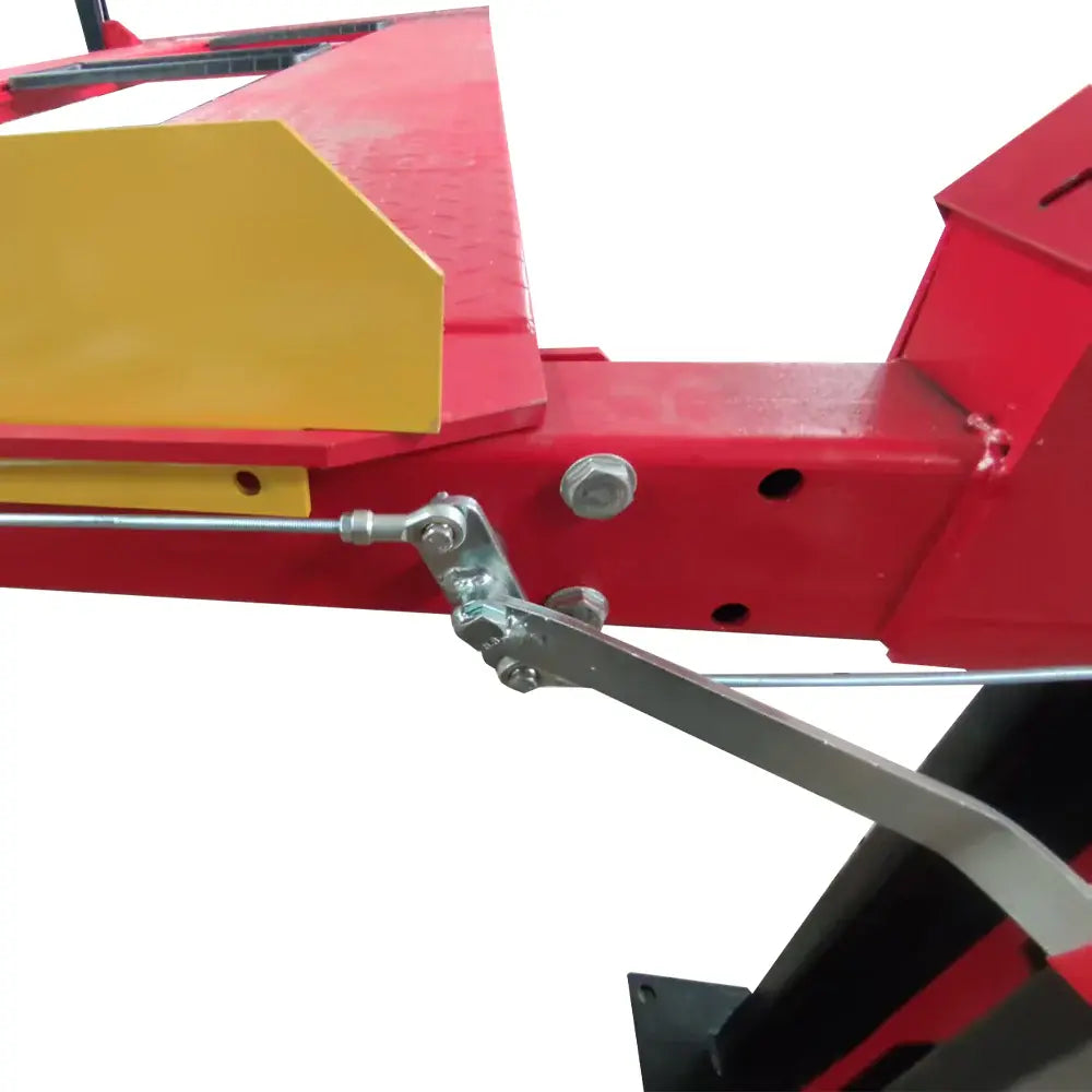 Four-post lift linkage and crossbar with red frame, steel rod assembly, and yellow safety blocks.