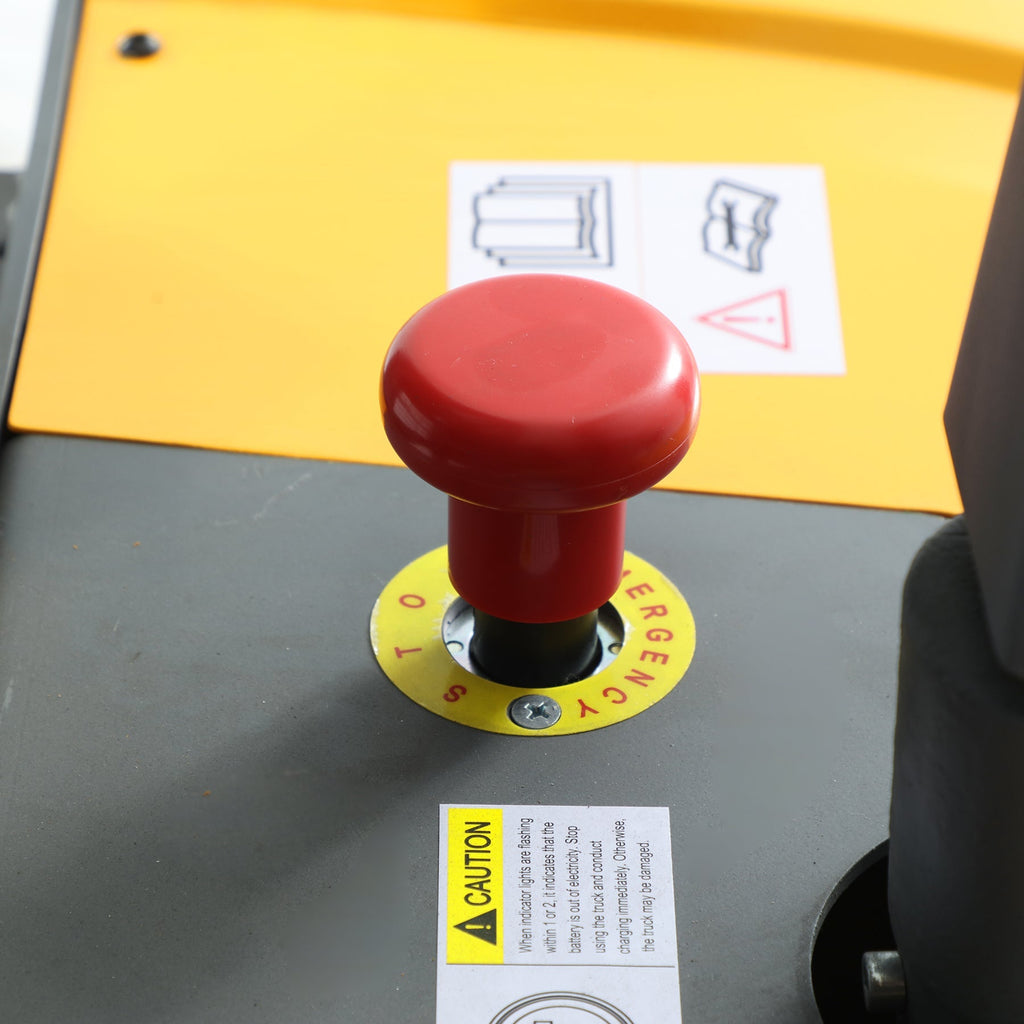 Red mushroom emergency stop with numbered yellow ring and caution label